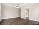 Bright living room with dark wood floors and chandelier at 2017 Belle Grove Dr, Waxhaw, NC 28173