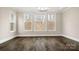 Bright living room with hardwood floors, recessed lighting, and large windows at 2017 Belle Grove Dr, Waxhaw, NC 28173