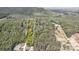 Aerial view showcasing the property's expansive land, nestled among lush greenery and trees at 298 Poplar Grove Ct, Taylorsville, NC 28681