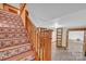 Stairway featuring decorative tile steps and a stained railing, leading to the finished basement at 298 Poplar Grove Ct, Taylorsville, NC 28681