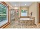 Bright bathroom featuring a glass-enclosed shower, soaking tub, and tiled flooring at 298 Poplar Grove Ct, Taylorsville, NC 28681