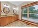 Bathroom with a double vanity, granite countertops, and a large window offering scenic views at 298 Poplar Grove Ct, Taylorsville, NC 28681