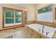 Elegant bathroom with a soaking tub, large windows, and a glass-enclosed shower at 298 Poplar Grove Ct, Taylorsville, NC 28681