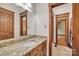Bathroom showcasing granite countertops and warm wood finishes, exuding elegance at 298 Poplar Grove Ct, Taylorsville, NC 28681