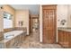 Bathroom featuring a tiled soaking tub, separate vanity, and private entrance at 298 Poplar Grove Ct, Taylorsville, NC 28681