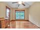 Bedroom featuring hardwood floors, a ceiling fan, and a large window offering bright natural light at 298 Poplar Grove Ct, Taylorsville, NC 28681