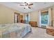 Cozy bedroom with a bed, dressers, and two windows offering outdoor views with wood trim at 298 Poplar Grove Ct, Taylorsville, NC 28681