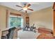 Bright bedroom featuring a ceiling fan and a large window overlooking the trees at 298 Poplar Grove Ct, Taylorsville, NC 28681