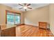 Bedroom featuring hardwood floors, a ceiling fan, and a large window allowing ample light at 298 Poplar Grove Ct, Taylorsville, NC 28681