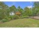 A beautiful gazebo sits in a landscaped backyard with mature trees and distant mountain views at 298 Poplar Grove Ct, Taylorsville, NC 28681