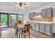 Charming kitchen and dining space with light gray cabinets and neutral-toned backsplash at 298 Poplar Grove Ct, Taylorsville, NC 28681