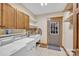 Functional laundry room with a sink, washer, dryer, storage cabinets, and exterior door at 298 Poplar Grove Ct, Taylorsville, NC 28681