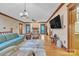 Open living room with hardwood floors, stone fireplace, and natural lighting at 298 Poplar Grove Ct, Taylorsville, NC 28681