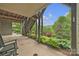 Covered patio with a view of the garden and lush greenery at 298 Poplar Grove Ct, Taylorsville, NC 28681
