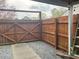 Fenced backyard featuring a wooden gate, providing privacy and security for outdoor enjoyment at 3738 Ashley Hall Dr, Charlotte, NC 28227