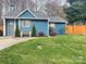 Charming blue home with a well-manicured lawn, freshly painted front door, and an inviting bench at 3738 Ashley Hall Dr, Charlotte, NC 28227