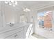 Well-lit bathroom with double vanity, large mirror, and a window offering natural light at 415 Spring St, Davidson, NC 28036