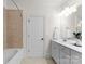 Clean bathroom with tiled shower and tub, and white vanity with modern fixtures at 415 Spring St, Davidson, NC 28036
