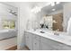 Bright bathroom features double sink vanity, and an open doorway to the bedroom at 415 Spring St, Davidson, NC 28036