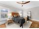 Comfortable bedroom with a woven headboard, neutral decor, and hardwood floors at 415 Spring St, Davidson, NC 28036