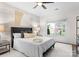 Cozy bedroom with a large window, ceiling fan, upholstered headboard and neutral color scheme at 415 Spring St, Davidson, NC 28036