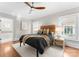Cozy bedroom featuring hardwood floors, neutral decor, and ample natural light from the windows at 415 Spring St, Davidson, NC 28036