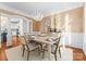 Bright dining area showcasing hardwood floors, designer lighting, and easy access to the kitchen at 415 Spring St, Davidson, NC 28036