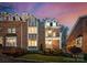 Elegant brick home with a well-kept lawn, a private balcony, and lush landscaping at 415 Spring St, Davidson, NC 28036