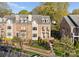 Charming brick townhome with dormer windows, balcony, and beautifully landscaped front yard at 415 Spring St, Davidson, NC 28036