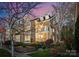 Charming brick home featuring a lovely garden, small balcony, and meticulous landscaping at 415 Spring St, Davidson, NC 28036