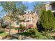 Charming front exterior with brick, a manicured lawn and landscaping and a small balcony at 415 Spring St, Davidson, NC 28036