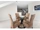 The game room has a glass round table with 4 wicker chairs, overlooking into another living area at 415 Spring St, Davidson, NC 28036