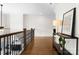 Spacious upper hallway with hardwood floors, decorative railing, and a stylish console table at 415 Spring St, Davidson, NC 28036