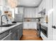 Well-equipped kitchen with white cabinets, stainless steel appliances, and a functional kitchen island at 415 Spring St, Davidson, NC 28036