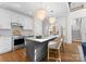 Modern kitchen featuring stainless steel appliances, a marble island, and stylish pendant lights at 415 Spring St, Davidson, NC 28036