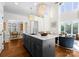 Open kitchen featuring a marble island, modern lighting, and seamless integration with the living and dining areas at 415 Spring St, Davidson, NC 28036