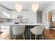 Bright kitchen featuring a marble island, stylish seating, stainless steel appliances, and pendant lighting at 415 Spring St, Davidson, NC 28036