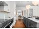 Elegant kitchen view leading to the dining area, showcasing hardwood floors and stainless steel appliances at 415 Spring St, Davidson, NC 28036