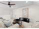 Relaxing living room with ceiling fan, modern art and a cozy round coffee table on a cowhide rug at 415 Spring St, Davidson, NC 28036