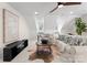 Cozy living room area with neutral colored furniture, hardwood accents, and lots of light at 415 Spring St, Davidson, NC 28036