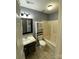 Standard bathroom featuring a shower-tub combo with gray walls and tile flooring at 4825 Banfshire Rd # 28, Charlotte, NC 28215