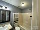 Standard bathroom featuring a shower-tub combo with gray walls and tile flooring at 4825 Banfshire Rd # 28, Charlotte, NC 28215