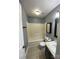 Standard bathroom featuring a shower-tub combo with gray walls and tile flooring at 4825 Banfshire Rd # 28, Charlotte, NC 28215