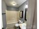 Standard bathroom featuring a shower-tub combo with gray walls and tile flooring at 4825 Banfshire Rd # 28, Charlotte, NC 28215