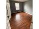 Cozy bedroom with fresh paint, wood-look floors, and natural light at 4825 Banfshire Rd # 28, Charlotte, NC 28215