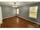 Bedroom with hardwood floors and two windows letting in natural light at 4825 Banfshire Rd # 28, Charlotte, NC 28215