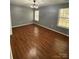 Bedroom with hardwood floors, two windows, and modern ceiling fan at 4825 Banfshire Rd # 28, Charlotte, NC 28215