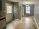 Inviting kitchen with tiled floor, white door to outside, and window for natural light at 4825 Banfshire Rd # 28, Charlotte, NC 28215