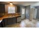 Kitchen with tile floors, gray cabinets, and stainless steel dishwasher at 4825 Banfshire Rd # 28, Charlotte, NC 28215