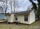 Rear exterior of house with siding, black trim windows, and a small deck at 4825 Banfshire Rd # 28, Charlotte, NC 28215